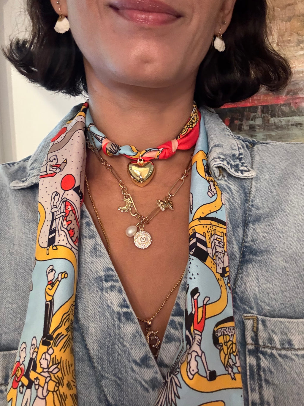 Woman wearing The Caroline silk scarf necklace with a denim button-down shirt