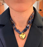 Woman wearing The Coley silk scarf necklace with a dark blazer