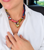 Woman wearing The Droubi silk scarf necklace with a classic white button-down