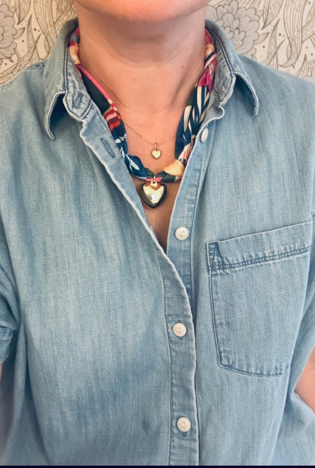 Woman wearing The Elise silk-blend scarf necklace with a denim button-down shirt