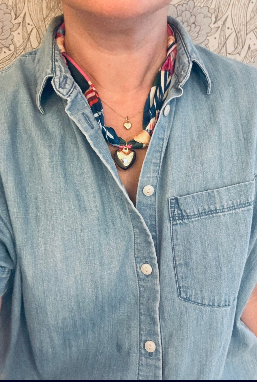 Woman wearing The Elise silk-blend scarf necklace with a denim button-down shirt