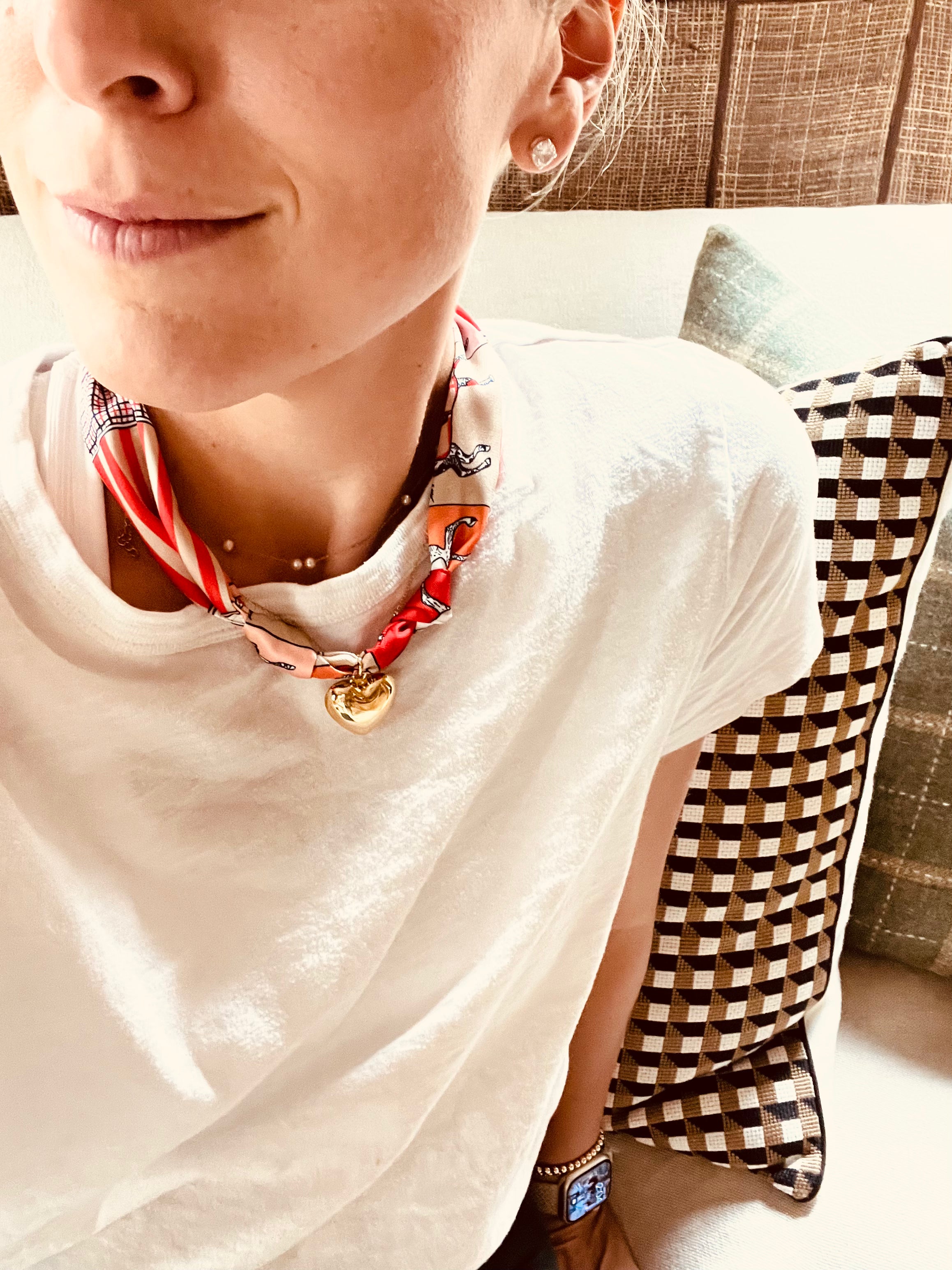 Woman wearing The Gigi silk-blend scarf necklace with a white t-shirt