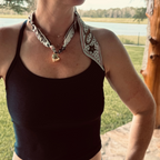 Woman wearing The Jen silk scarf necklace with a black tank top