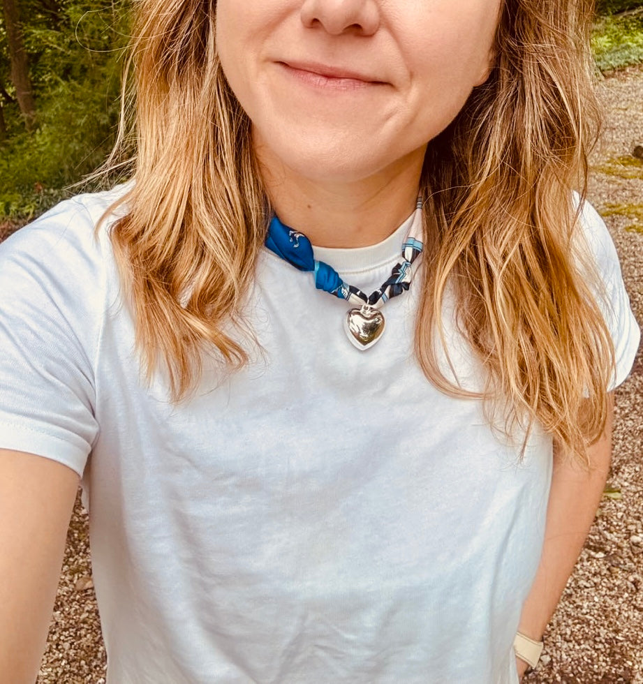 Woman wearing The Jojo silk-blend scarf necklace with a classic white tee