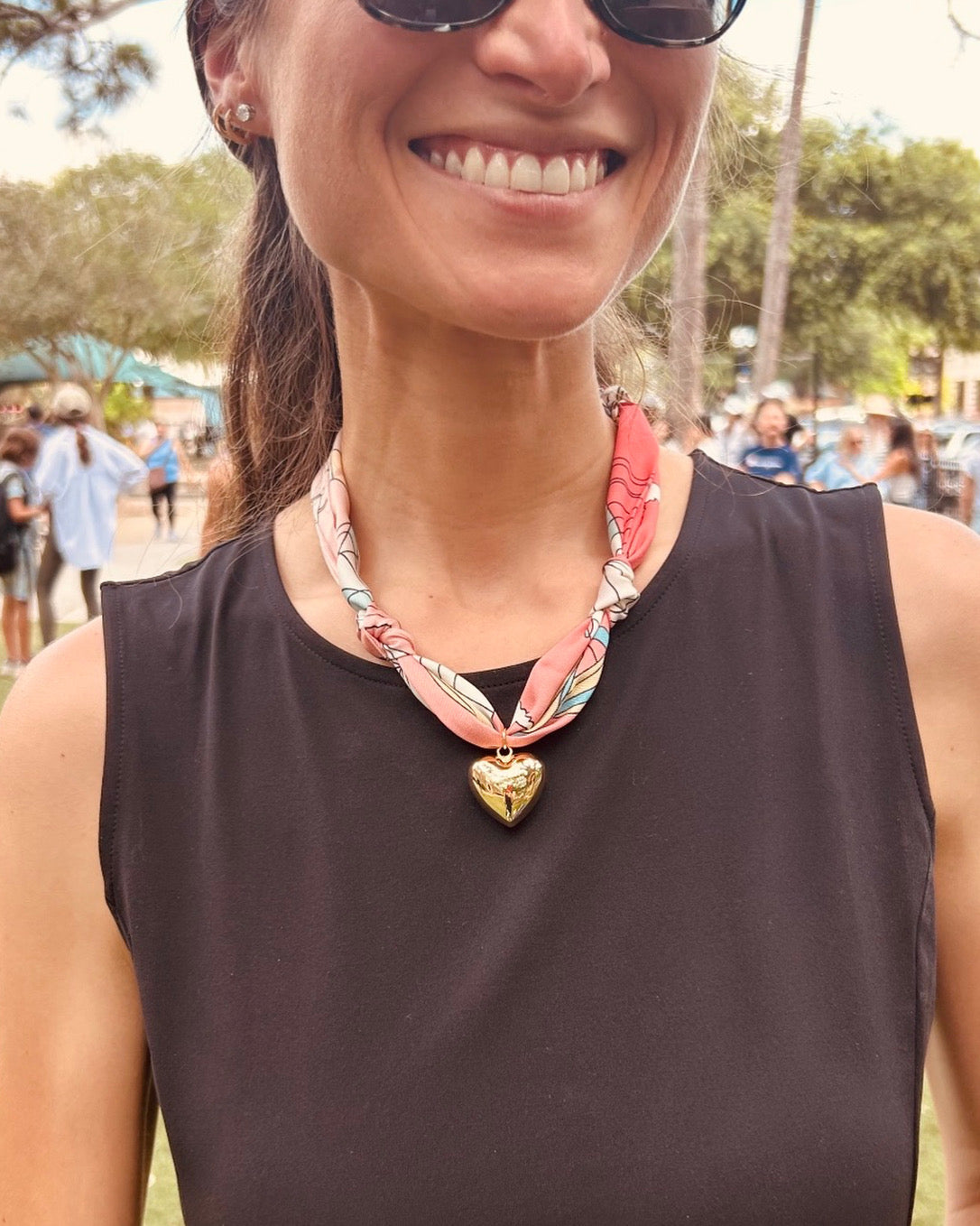 Woman wearing The Kate silk-blend scarf necklace with a brown tank top