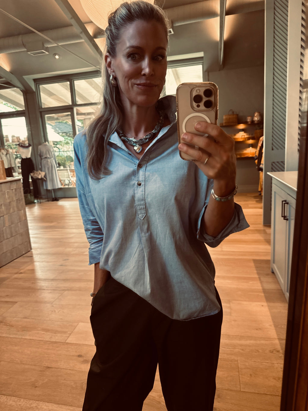 Woman wearing The Kelly silk-blend scarf necklace with a classic denim button down