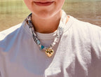 Woman wearing The Kelsey silk-blend scarf necklace with a white t-shirt