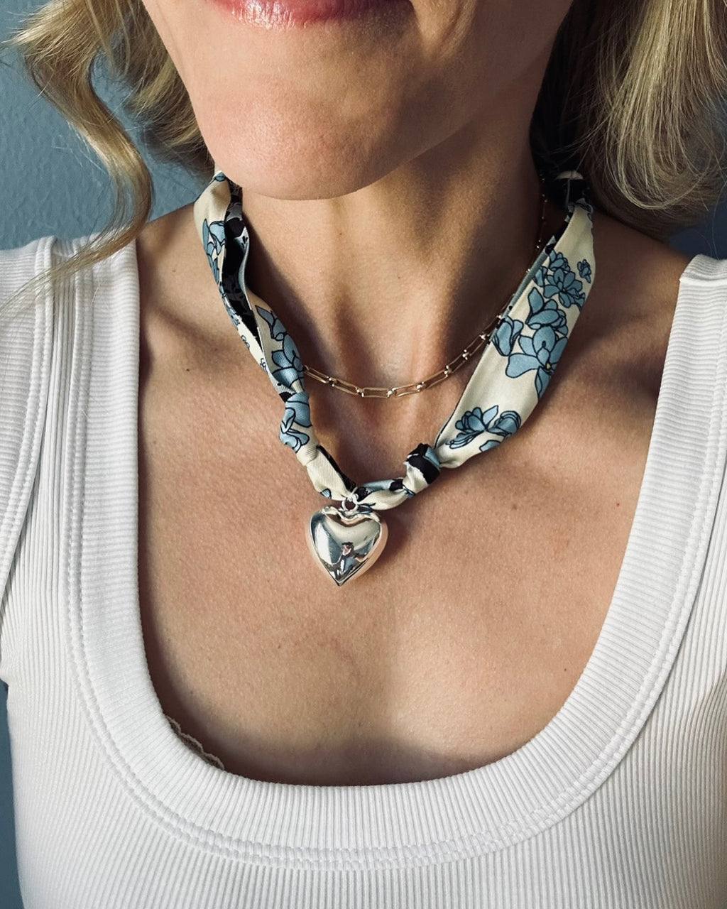 Woman wearing The Lauren silk scarf necklace with a white tank top