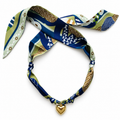 The Margot silk scarf necklace in green and blue print with gold heart pendant