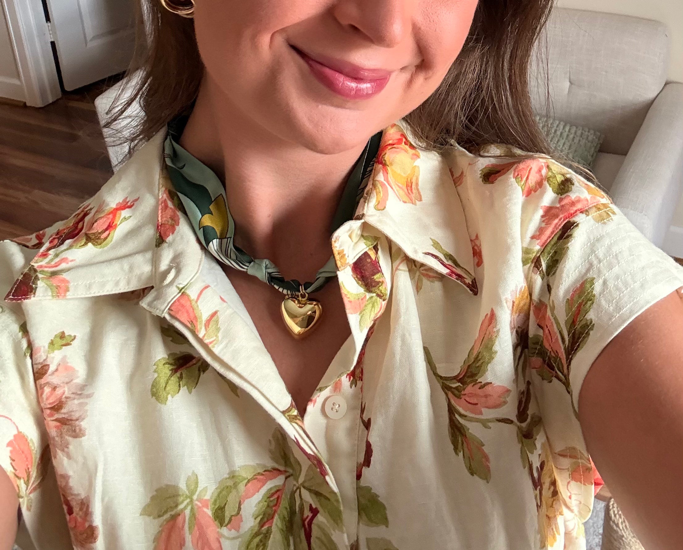 Woman wearing The Monica silk scarf necklace with a floral print button-down shirt