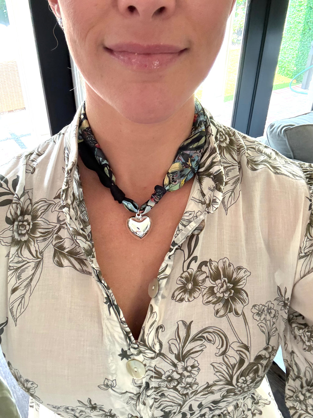 Woman wearing The Nicole silk scarf necklace with a white print button-down