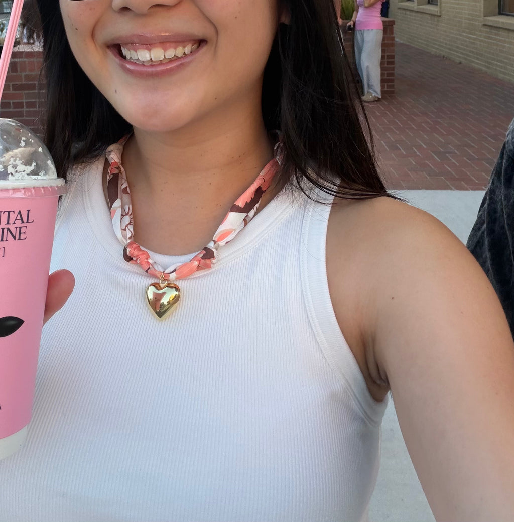 Woman wearing The Olivia scarf necklace with a white tank top